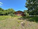 Rear view of a quaint, single-story brick home surrounded by a yard at 80 Dunn Rd, Louisburg, NC 27549