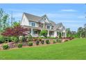 Charming two-story home with manicured lawn and beautiful landscaping adding to its curb appeal at 808 Wimberly Rd, Apex, NC 27523