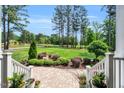 Inviting front yard with stone walkway and stairs, lush plants and trees, and a view of the expansive lawn at 808 Wimberly Rd, Apex, NC 27523