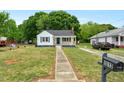 View of the home's exterior showcasing the sidewalk, front lawn, and inviting facade at 1012 Rainey St, Burlington, NC 27217