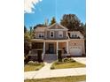 Inviting two-story home featuring a covered front porch, attached garage, and manicured lawn at 102 Kipling Dr, Oxford, NC 27565