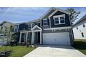 Charming home featuring gray siding, a two-car garage, and a well-manicured front lawn at 1033 Bostonian Dr, Knightdale, NC 27545