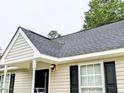 A well-maintained house featuring beige siding, black shutters, and a durable gray roof at 106 Grange Dr, Wendell, NC 27591