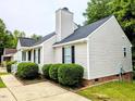 A view of the side of the home, showcasing the siding, windows, and well-maintained landscaping at 106 Grange Dr, Wendell, NC 27591