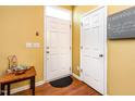 Bright foyer with wood flooring, a coat closet, and a charming entry table at 1220 Canyon Rock Ct # 107, Raleigh, NC 27610