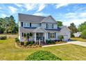 Charming two-story home with attached garage, well-manicured lawn, and inviting front porch at 128 Christy Ln, Dunn, NC 28334