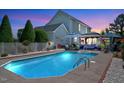 Sparkling pool surrounded by an outdoor lounge area with comfortable seating and a gazebo at 128 Christy Ln, Dunn, NC 28334