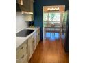 Galley style kitchen with countertops, wooden floors and stainless steel appliances at 1345 Ellis Rd, Durham, NC 27703