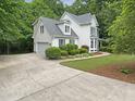 Charming two-story home with manicured landscaping, attached garage, and a concrete driveway at 150 Remington Ct, Youngsville, NC 27596