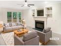 Bright and inviting living room with a cozy fireplace and built-in shelving at 150 Remington Ct, Youngsville, NC 27596
