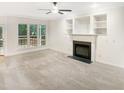 A view of the Living Room with fireplace and built in cabinets, with view to the outside Deck at 150 Remington Ct, Youngsville, NC 27596