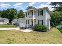 Attractive two-story home featuring a gray exterior with black shutters and an attached garage at 187 Ashley Woods Ct, Clayton, NC 27527