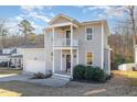 Beautiful two-story home with welcoming porch, attached garage, and lovely landscaping on a sunny day at 187 Ashley Woods Ct, Clayton, NC 27527