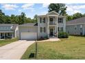 Charming two-story home with a gray exterior, black shutters, and a well-maintained front yard at 187 Ashley Woods Ct, Clayton, NC 27527