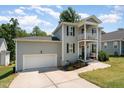 Well-maintained two-story home with a front-facing two-story porch and attached garage at 187 Ashley Woods Ct, Clayton, NC 27527