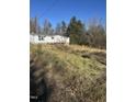 Modest single story house with wooded surroundings at 1916 E Hughes Mill Rd, Burlington, NC 27217