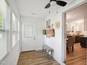 Hallway view featuring new flooring, modern white walls, and a bench for added convenience at 205 S Pettigrew St, Raleigh, NC 27610
