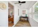 Office area with new flooring, a modern desk, and an inviting view to the living room at 205 S Pettigrew St, Raleigh, NC 27610