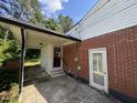 Backyard view of home's covered carport and brick siding at 2131 Dandridge Dr, Raleigh, NC 27610