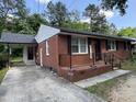 Brick home with covered carport and front porch at 2131 Dandridge Dr, Raleigh, NC 27610