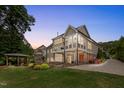 Beautiful backyard featuring a two-story home with a patio and a separate covered outdoor seating area at 233 Hein Dr, Clayton, NC 27527