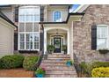 Inviting front entrance with stone steps, manicured landscaping, and a charming front door at 233 Hein Dr, Clayton, NC 27527
