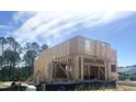 Image of a new construction home showing the framed exterior and roof against a blue sky at 236 Golfview Ave, Benson, NC 27504