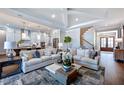 Bright living room with coffered ceilings, stylish sofas, and open access to the kitchen at 249 Lindo Johnson Rd, Pittsboro, NC 27312