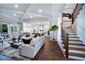 Sunlit living room showcasing hardwood floors, coffered ceilings, and staircase at 249 Lindo Johnson Rd, Pittsboro, NC 27312
