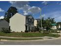 Side exterior view of the house showing the yard and street at 2612 Beagle Landing Dr, Raleigh, NC 27610