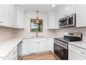 Recently renovated kitchen with stainless steel appliances and white cabinets with contemporary hardware at 2712 Nc 57, Hillsborough, NC 27278