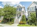 Charming two-story home with white siding, front stairs, and inviting curb appeal at 277 Douglas Falls Dr, Wendell, NC 27591