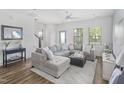 Bright living room with stylish gray sectional sofa, white walls, and lots of natural light at 277 Douglas Falls Dr, Wendell, NC 27591