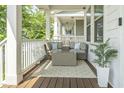 Relaxing outdoor porch seating area with cushioned furniture and neutral rug at 277 Douglas Falls Dr, Wendell, NC 27591