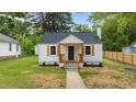Charming home featuring a walkway leading to the front door and neat landscaping at 306 Coleman St, Oxford, NC 27565