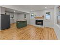 Bright open floor plan with wood floors and modern island overlooking the fireplace at 306 Coleman St, Oxford, NC 27565