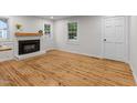 Bright living room with a fireplace, wood floors, and ample natural light at 306 Coleman St, Oxford, NC 27565
