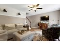 Comfortable living room featuring stylish furniture, patterned wallpaper accent and ceiling fan at 309 Cross Hill Ln, Holly Springs, NC 27540