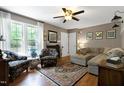 Inviting living room with a plush sofa, patterned accent chairs, and a large window for ample light at 309 Cross Hill Ln, Holly Springs, NC 27540