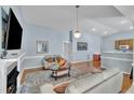 Open-concept living room with hardwood floors, a fireplace, and easy access to the kitchen at 316 Waterford Dr, Clayton, NC 27520