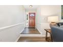 Inviting foyer with hardwood floors, leading to a stylish wooden front door and a glimpse of the outdoors at 400 Southerby Dr, Garner, NC 27529