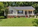 Cozy single-story home with a neat front lawn, complemented by a charming front porch and brick foundation at 400 Southerby Dr, Garner, NC 27529