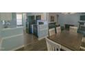 Open-concept living area with hardwood floors, a dining table, and direct kitchen access at 400 Southerby Dr, Garner, NC 27529