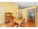 Sunny dining area features hardwood floors and traditional wooden furniture at 4017 Huckleberry Dr, Raleigh, NC 27612