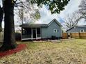 Expansive backyard with lawn, a screen door porch, landscape features, and mature trees at 425 Price Ave, Durham, NC 27707