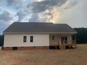 The home features a back porch, white siding, a dark roof and a spacious yard at 519 Mulberry Rd, Spring Hope, NC 27882