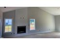 Spacious living room with a modern fireplace and large windows for natural light at 519 Mulberry Rd, Spring Hope, NC 27882