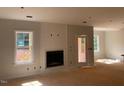 Unfinished living room with windows and a fireplace at 529 Mulberry Rd, Spring Hope, NC 27882