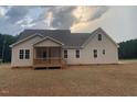 Single-story home showcasing a covered back patio with a backyard, perfect for outdoor relaxation and entertaining at 529 Mulberry Rd, Spring Hope, NC 27882