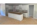 Spacious kitchen featuring white cabinets and a large island ready for finishing at 539 Mulberry Rd, Spring Hope, NC 27882